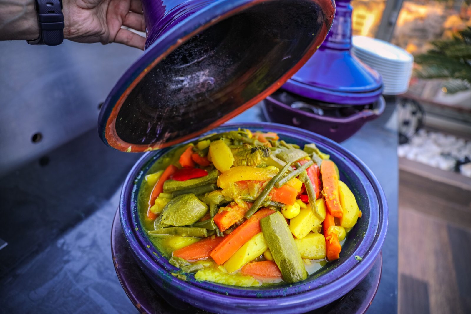 Gallery A colorful Moroccan tagine with fresh vegetables being uncovered, showcasing vibrant and healthy cuisine.